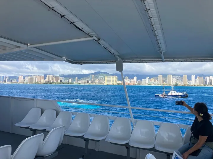 The open deck of the shuttle boat with Waikiki's hotels in the distance
